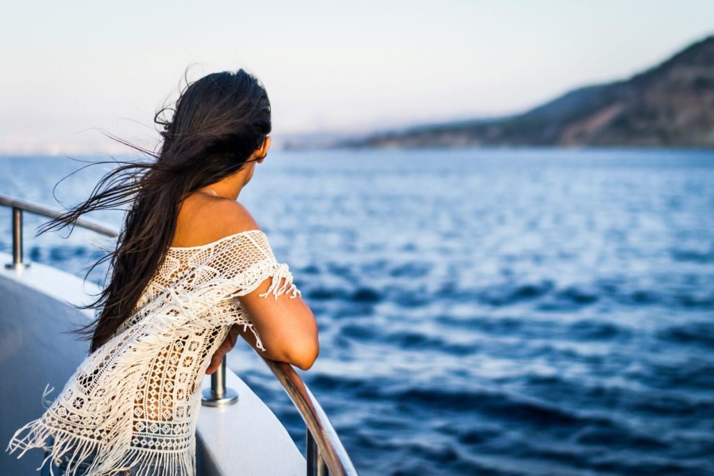 A passenger enjoying the view on a ship in the ocean