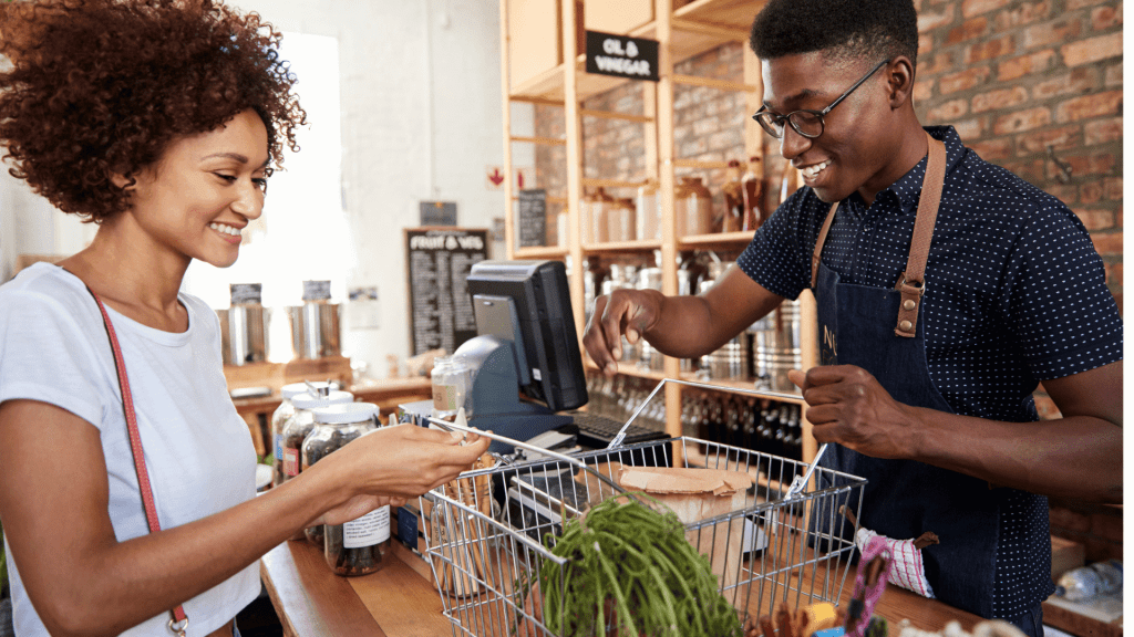 Person looking happy redeeming rewards at a grocery store