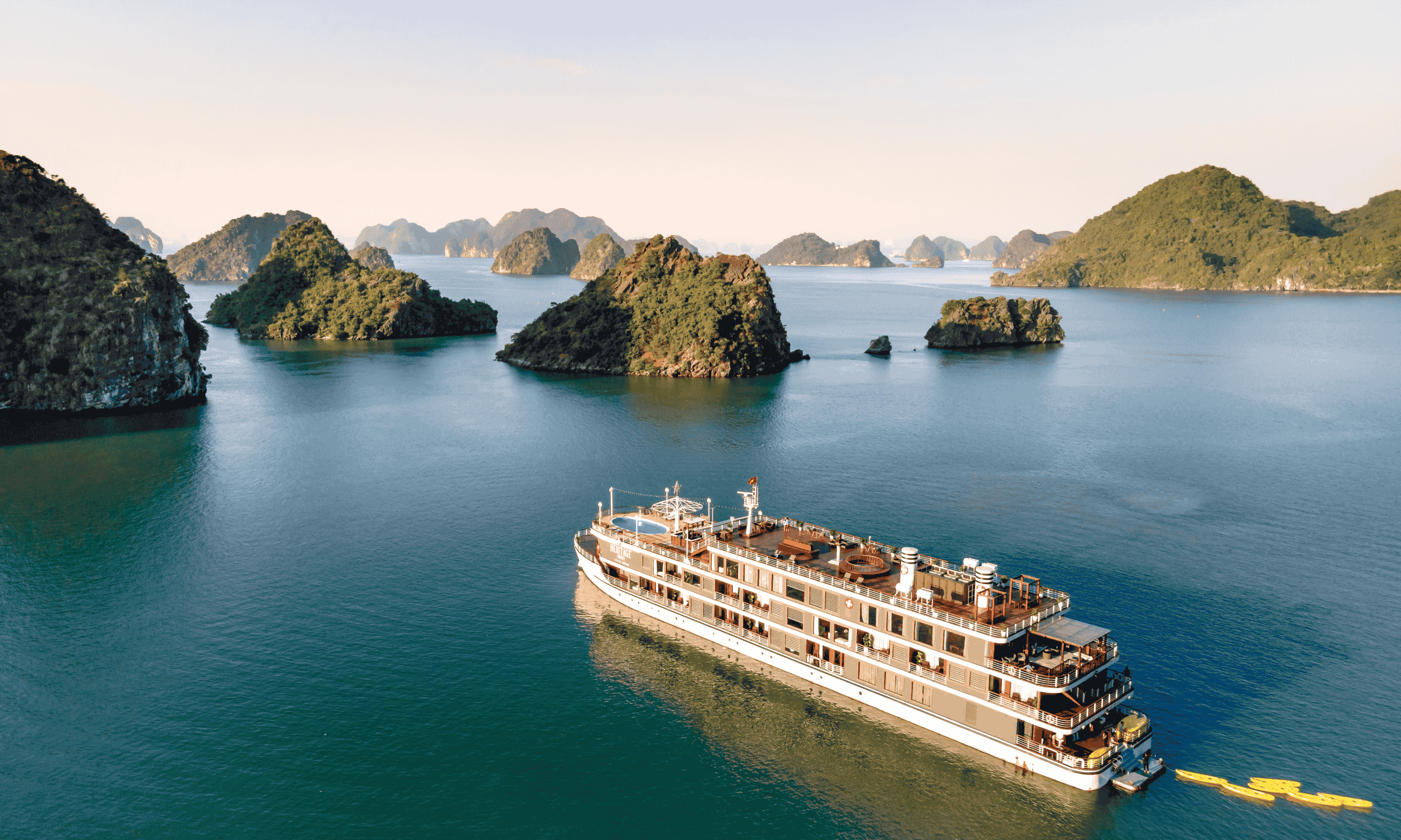 A cruise ship sailing near mini islands in an ocean demonstrating the growing strength of cruise tourism