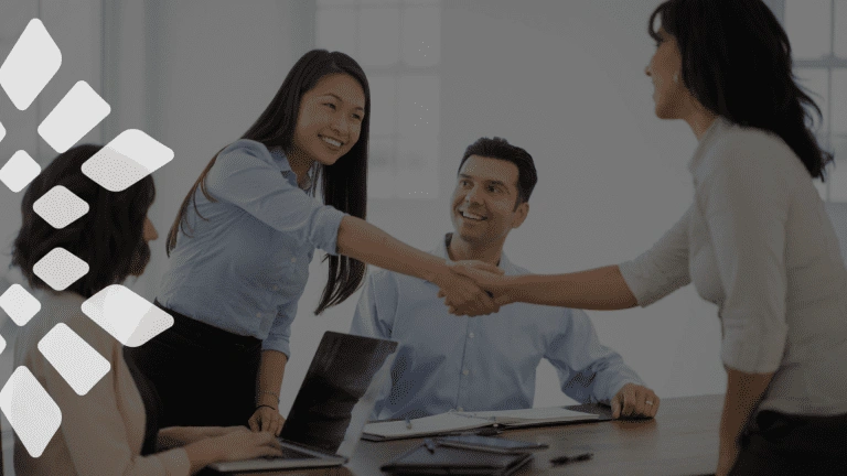 Corporate team meeting featuring a handshake to symbolize business partnership and agreement