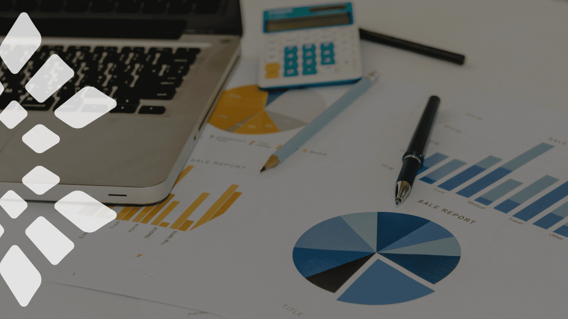 Laptop, calculator, and financial reports with charts and graphs on a desk